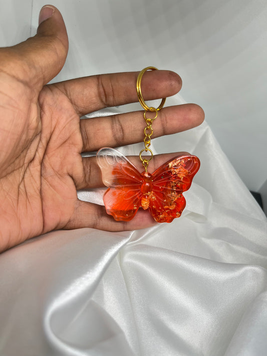 Porte clé papillon rouge avec feuilles d’or