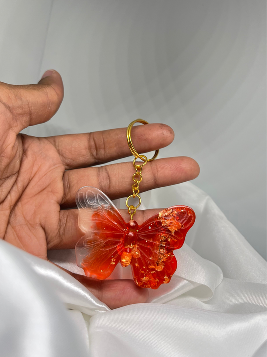 Porte clé papillon rouge avec feuilles d’or